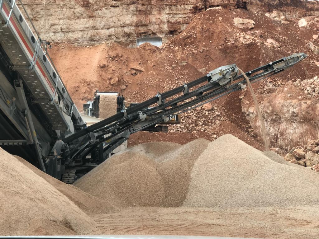 Mobile crusher discharging onto stockpile